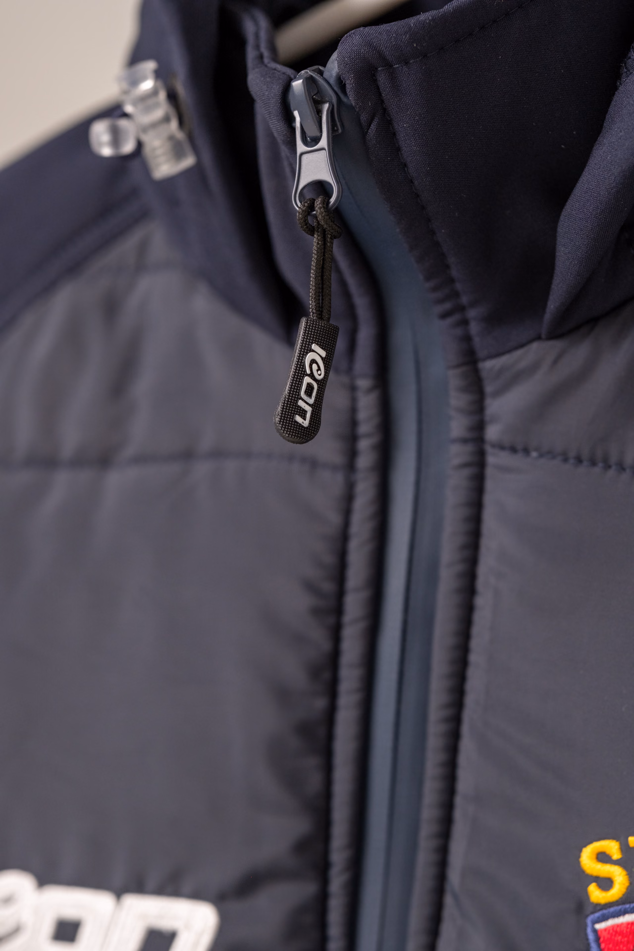 Close-up of an Icon Sports jacket zip and garment construction