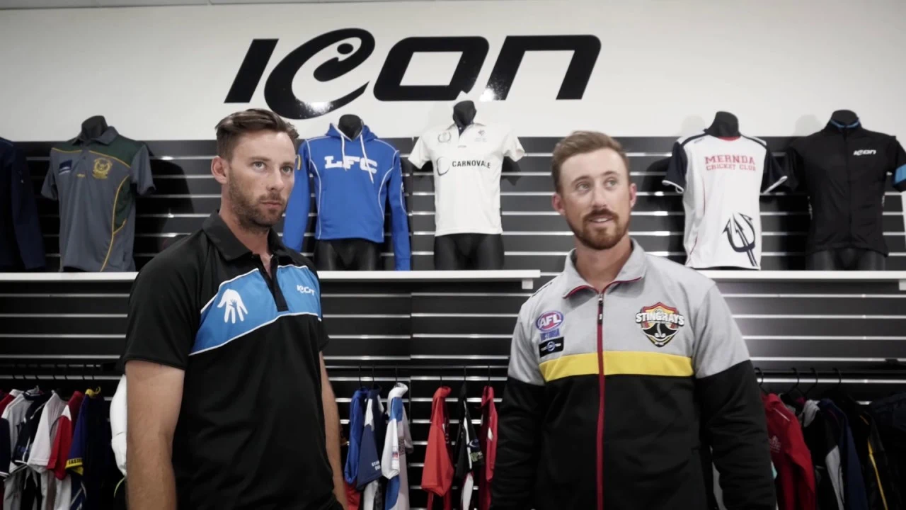 Two presenters in front of Icon Sports apparel in a showroom